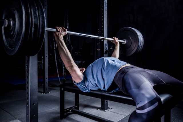 Should you arch your back during barbell bench press?
